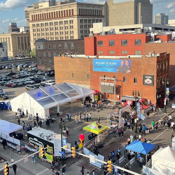 Aerial view of Firebird Tavern's outdoor event with tents, food trucks, and many people.