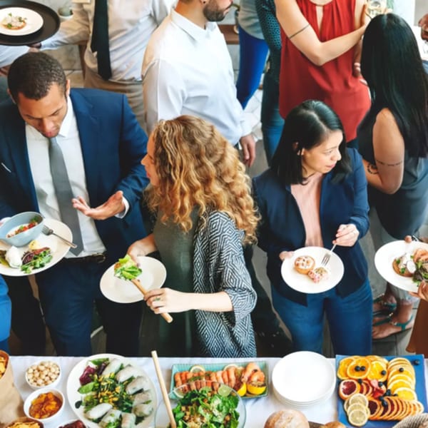 Guests at Firebird Tavern's bar-and-grill buffet, serving themselves from a spread of appetizers and salads.